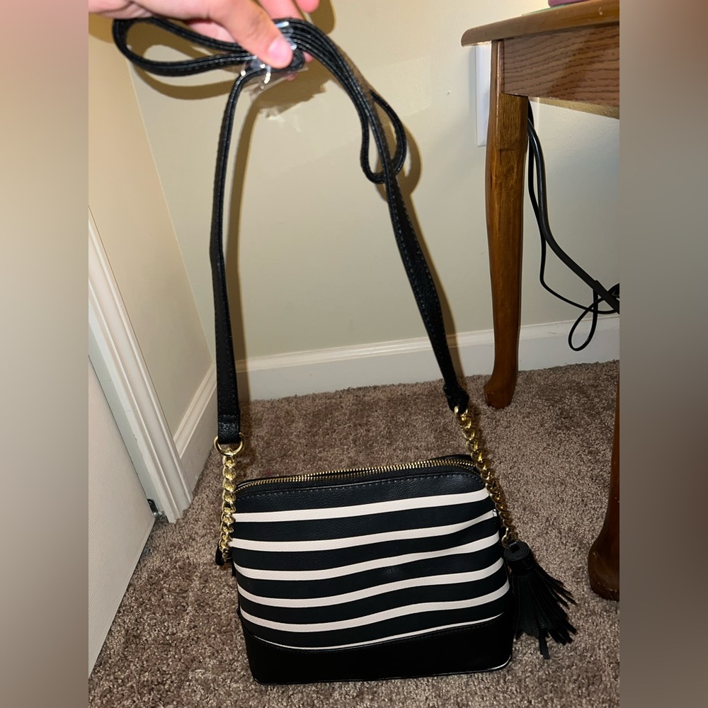 This is a medium size crossbody purse. It is brand new, never been used.